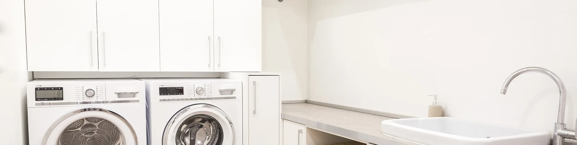 Custom laundry room storage cabinets with folding counter